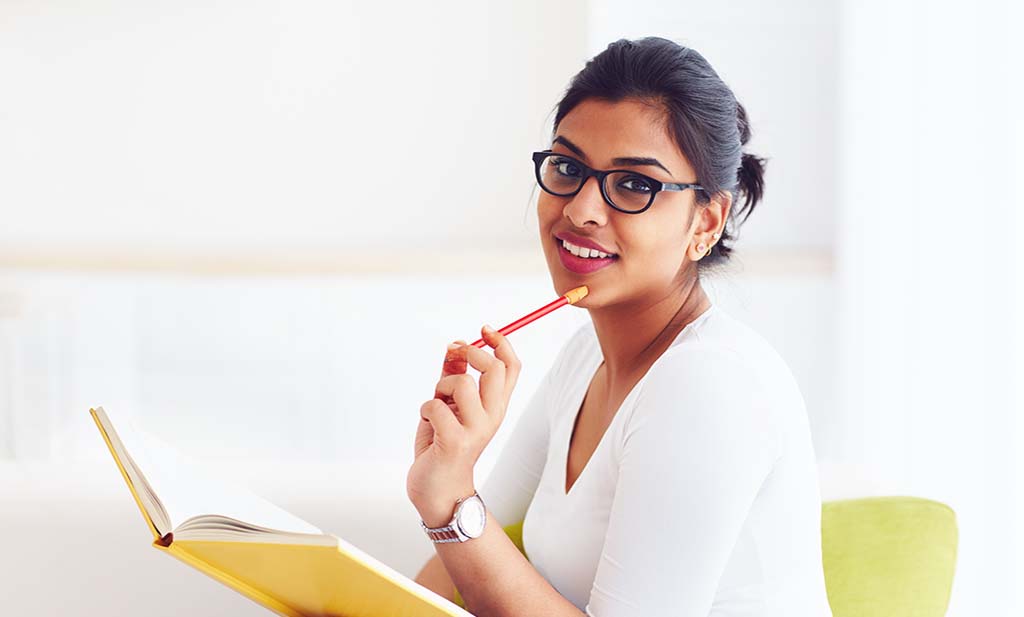 female student holding notebook pen