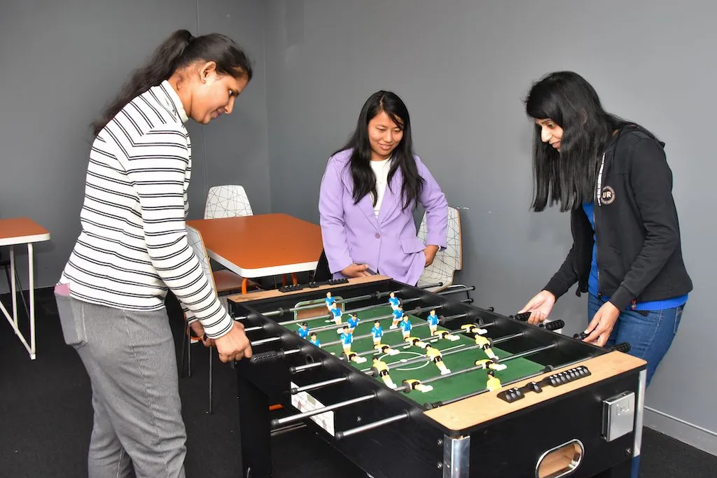 unisq sydney students playing foosball